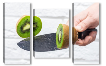Модульная картина Floating knife slicing trough kiwi fruit.